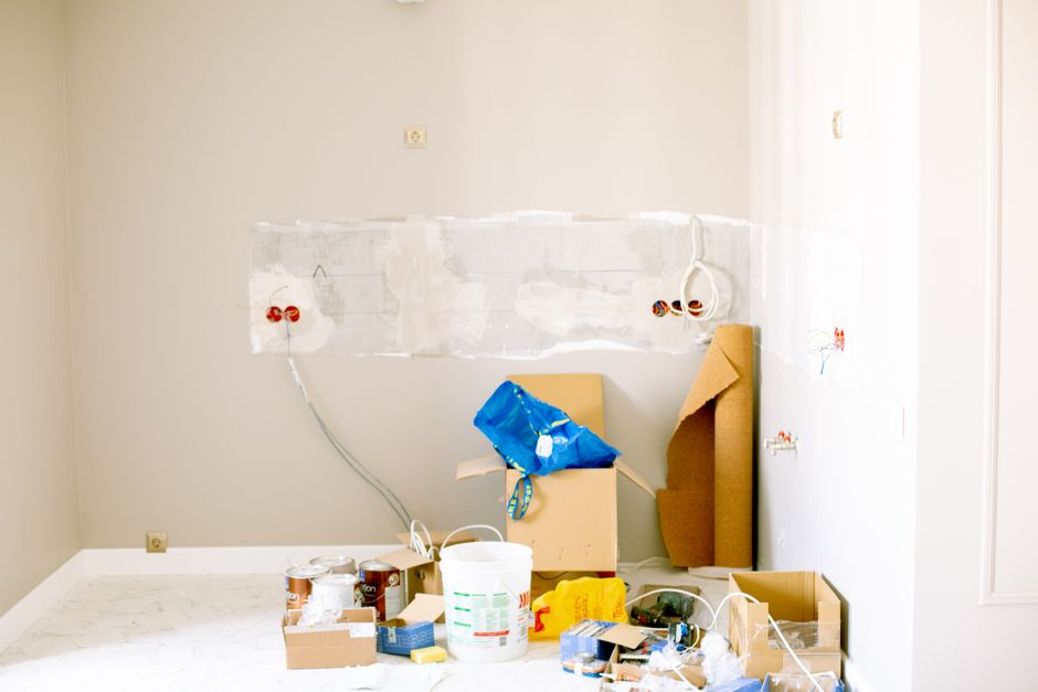 Room under repair with tools and supplies on the floor