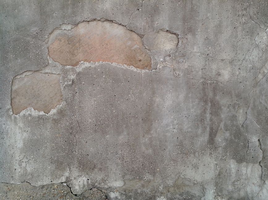 Close-up of a wall with exposed patched areas