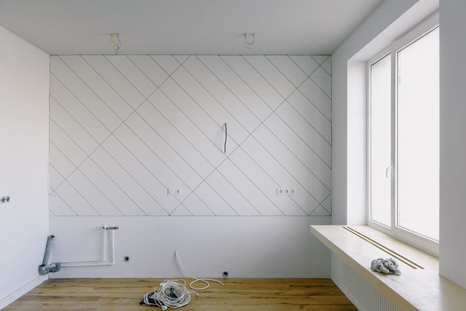 Interior room with bare walls during repair work