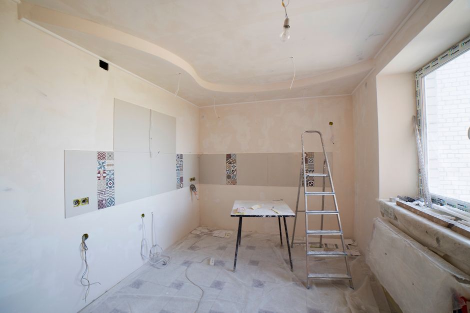 Room under renovation with a ladder and tools